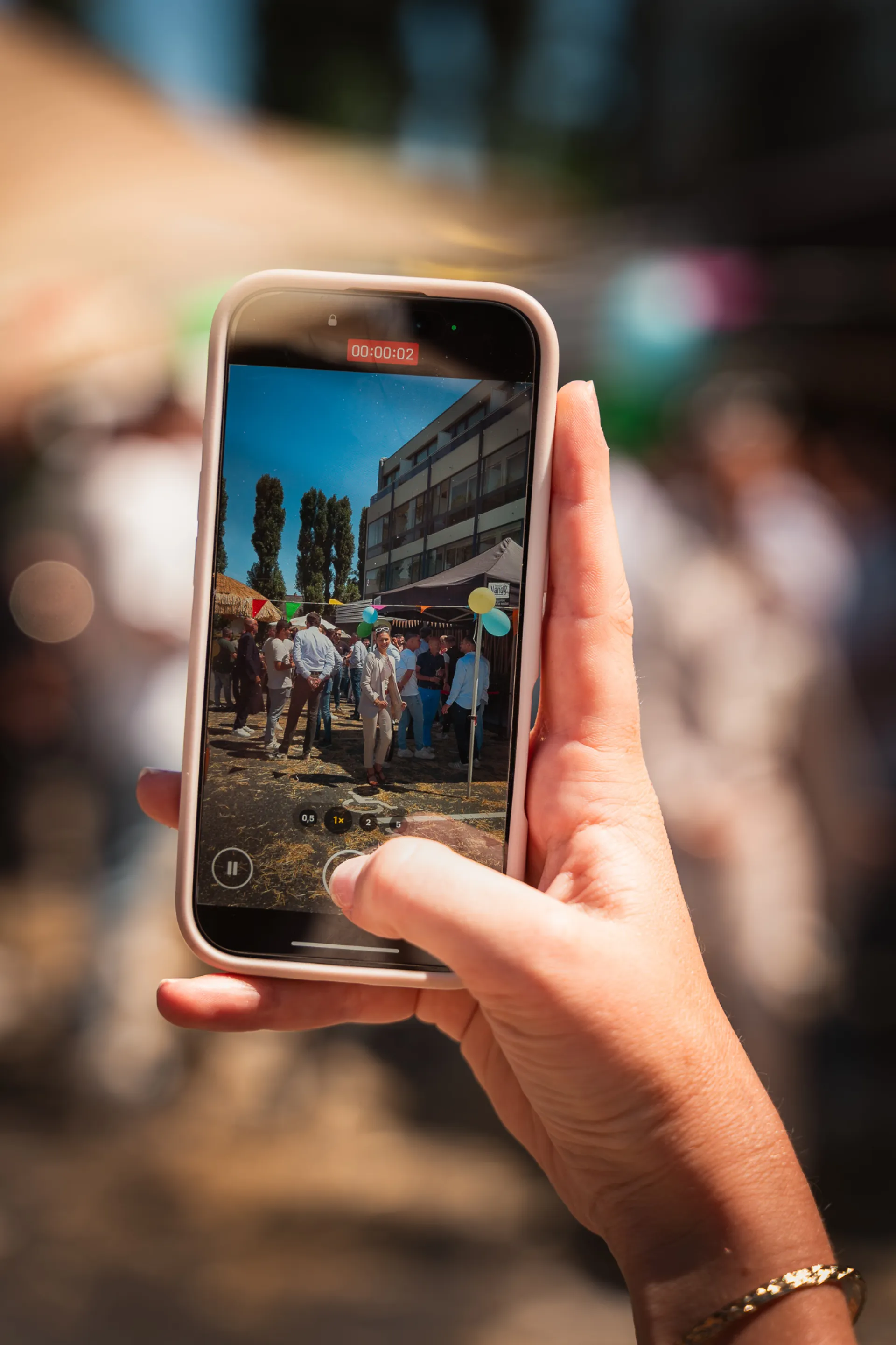 Main filmant une fête avec un smartphone